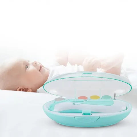 A baby lies on a soft surface in the background, with an open light blue manicure set containing colorful tools in the foreground.