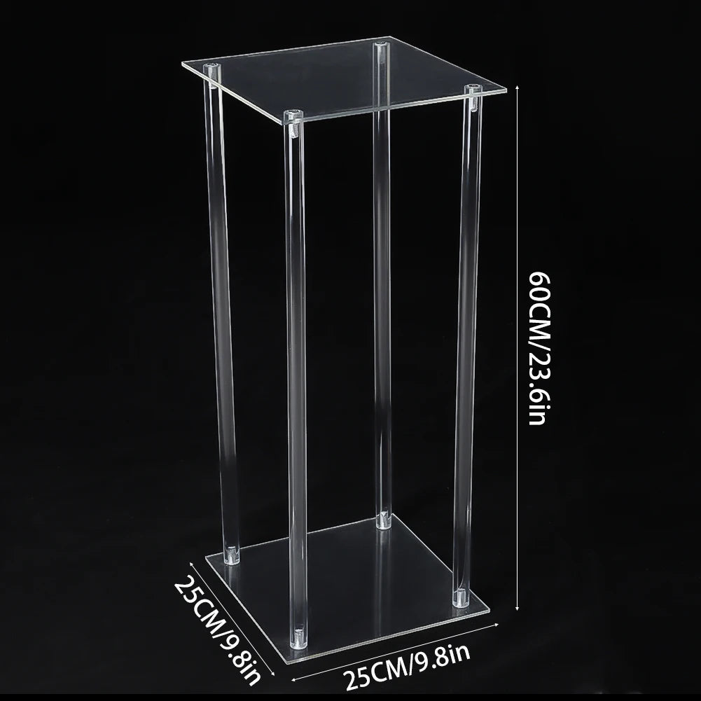 Clear acrylic pedestal measuring 60 cm in height, with a square base and top of 25 cm each. The transparent structure is set against a black background.