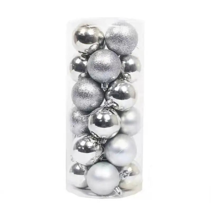 A collection of shiny and glittery silver Christmas baubles packed in a clear cylindrical container, featuring both matte and glossy finishes.