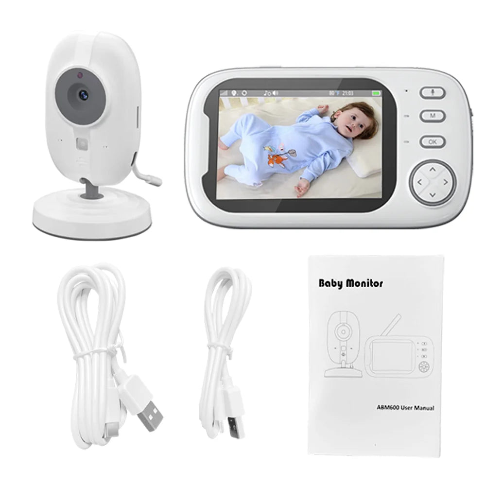 Baby monitor set with a camera, display showing a baby, two USB cables, and a user manual. The display shows a baby in a blue outfit lying on a bed.