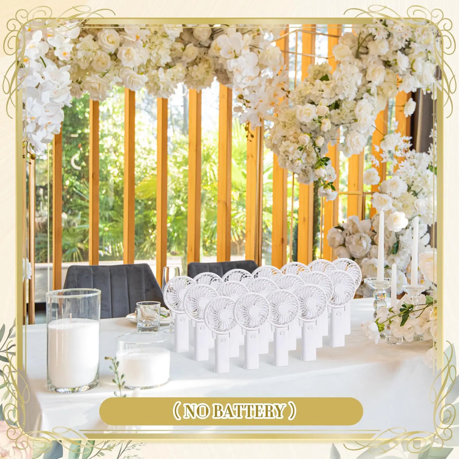 Table with white handheld fans and "No Battery" text, set in a floral-decorated room filled with white flowers and leafy plants.