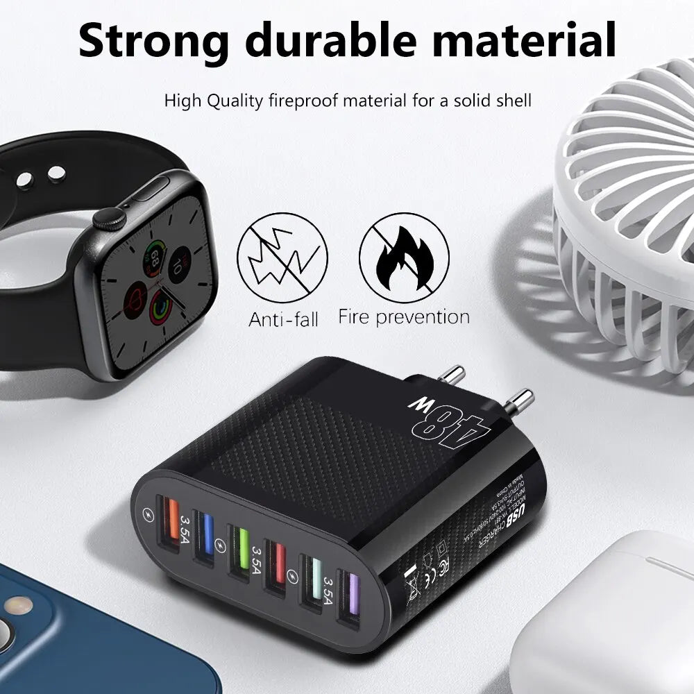 Black USB charger with multiple ports labeled 3.5A, anti-fall and fire prevention icons, beside a smartwatch, phone, and small fan. Text: "Strong durable material."