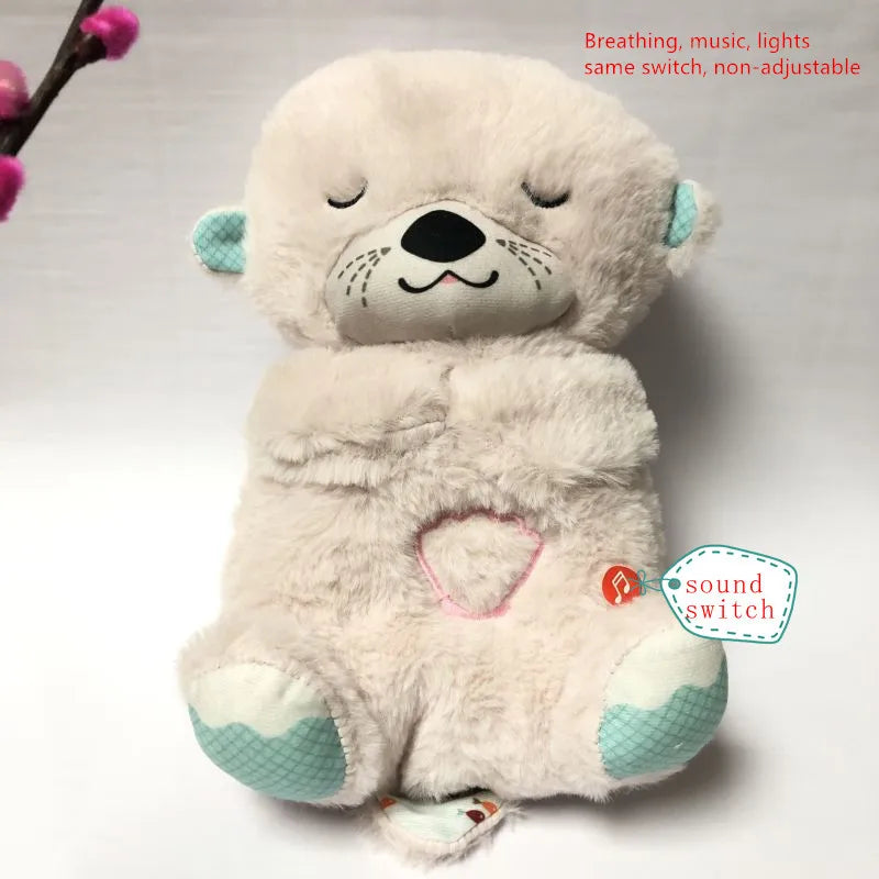 Cute plush otter toy with pink heart detail, teal ears, and paws. Features breathing, music, and lights controlled by a non-adjustable switch. Pink flowers in the background.