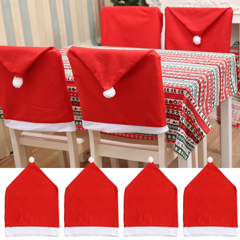 Chairs with Santa hat chair covers around a table decorated with a festive red, green, and white tablecloth featuring holiday patterns.