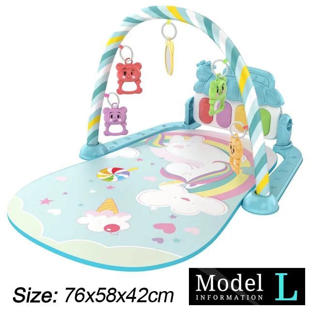 Baby play mat with a colorful arch and hanging toys, featuring clouds and rainbows on a pastel blue surface. Dimensions: 76x58x42cm. Model L.