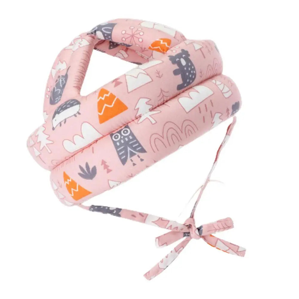 Pink padded toddler safety helmet featuring cute animal and nature designs with adjustable straps for a secure fit.