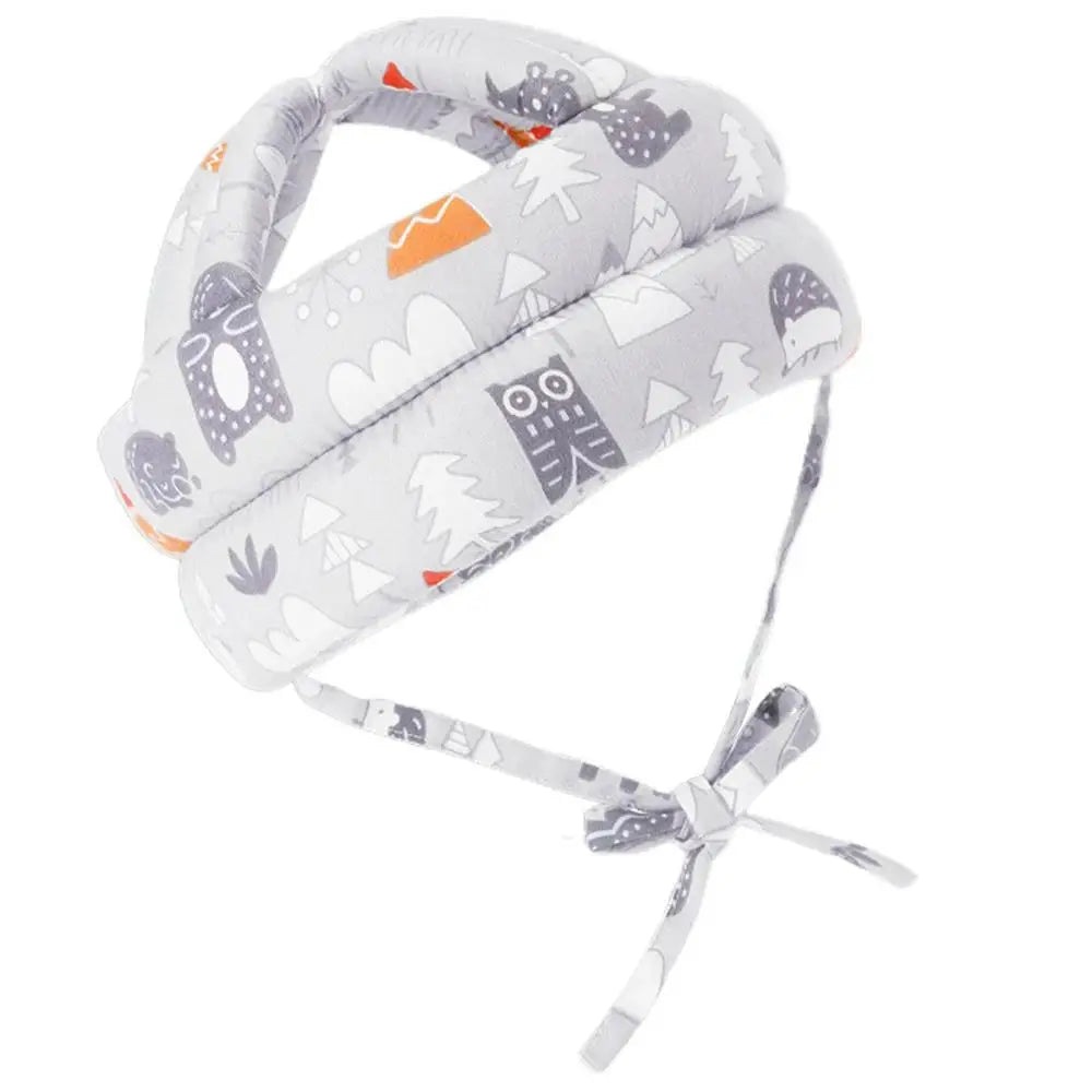 Soft, padded baby helmet with playful woodland animals and trees print in grey and white. Features adjustable straps for a secure fit.