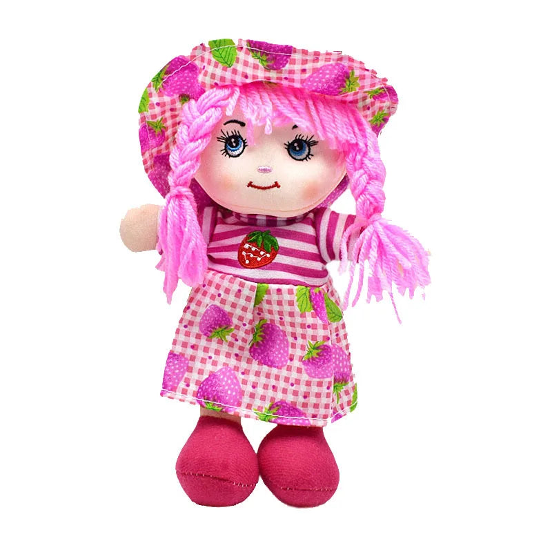 Cute doll with pink braided hair, wearing a hat and dress featuring strawberry patterns. The doll has a striped shirt with a strawberry decal and red shoes.