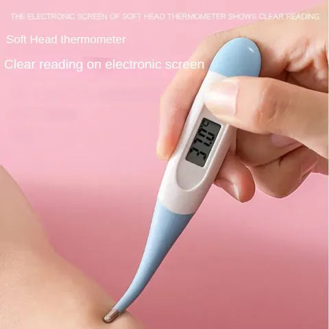 A hand holds a digital thermometer with a soft blue tip, displaying a clear reading on its screen. The thermometer is being used, set against a pink background.