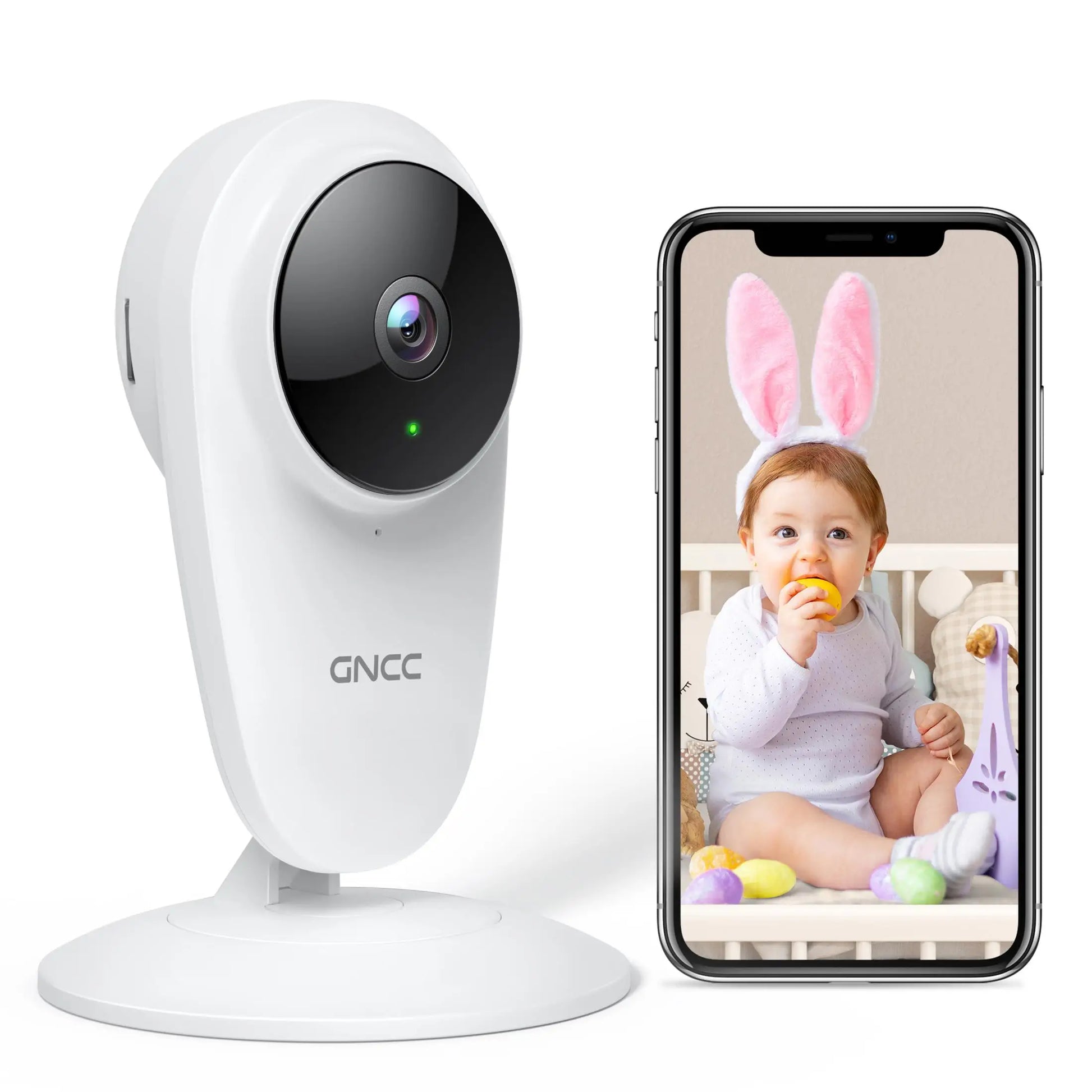A white GNCC security camera is next to a smartphone displaying a baby with bunny ears, sitting in a crib, and holding a toy egg.