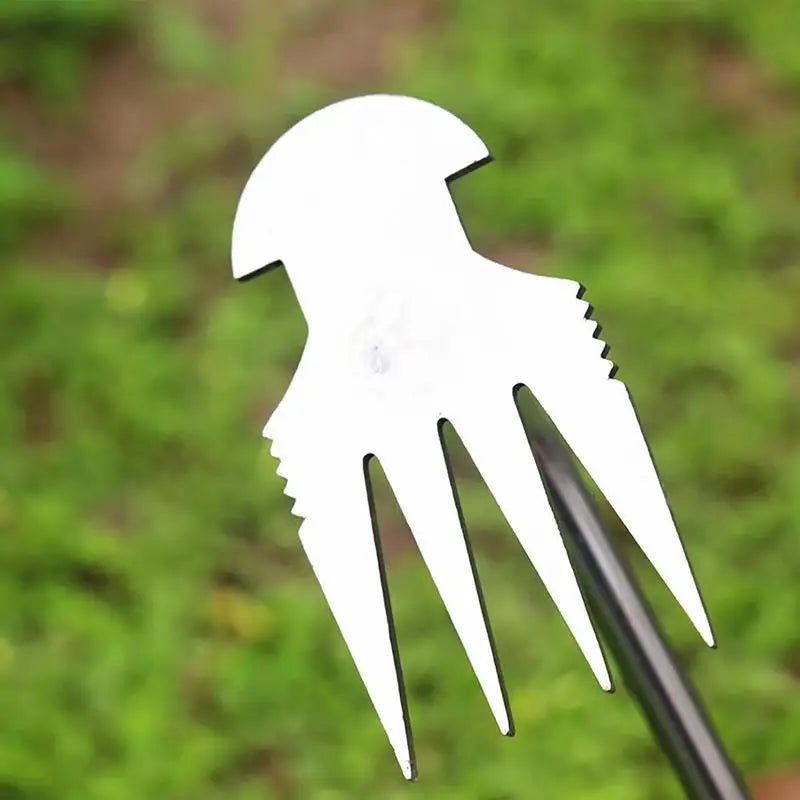 Small, metal garden fork with a unique, stepped design on a green background, used for soil cultivation and weeding.