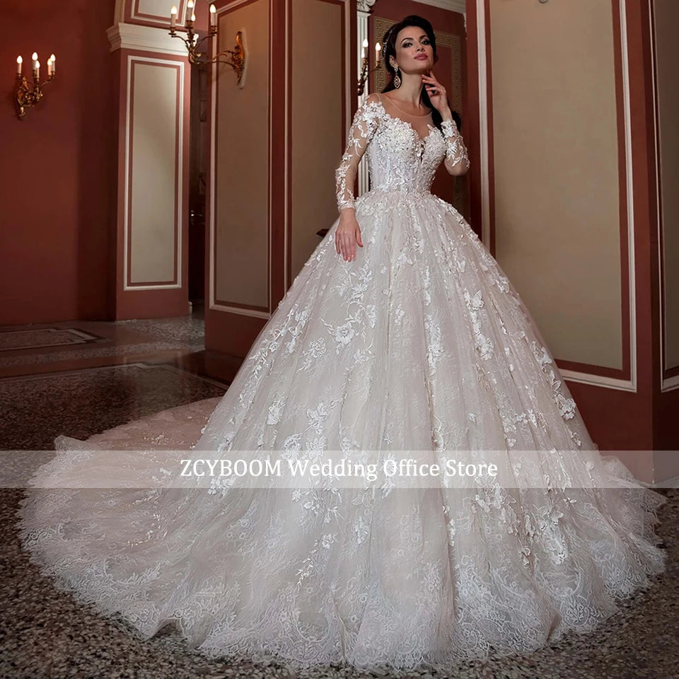Bridal gown with intricate lace detailing, long sleeves, and a voluminous skirt, worn by a woman in an elegant room with red walls and gold accents.