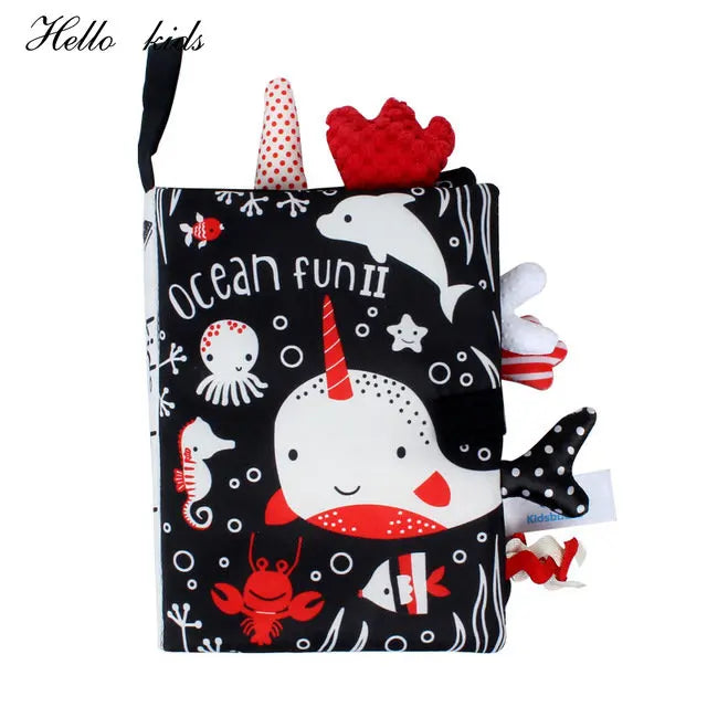 Kids' soft fabric book titled "Ocean Fun II" featuring a narwhal, dolphin, octopus, seahorse, and crab. The cover is black with red and white sea-themed designs.