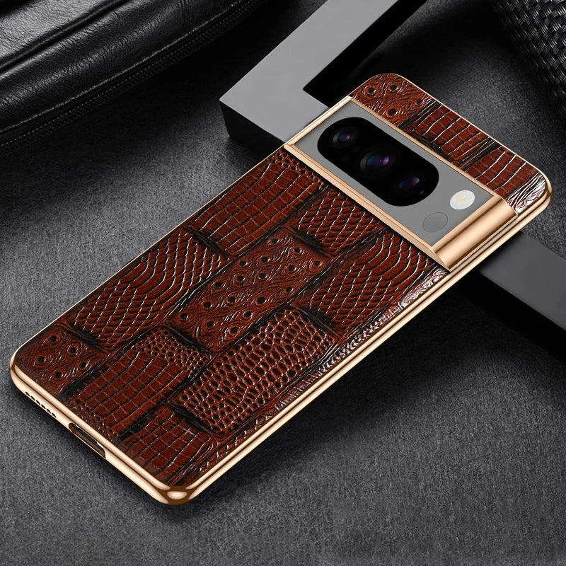 Smartphone with textured brown leather case featuring a gold camera border, placed on a dark surface near a black cushion.