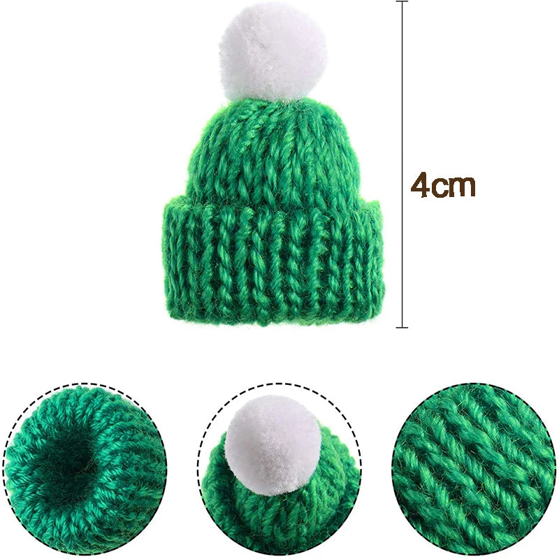A small green knitted hat with a white pom-pom, measuring 4 cm. Three close-up views highlight the hat's opening, the pom-pom, and the knit texture.