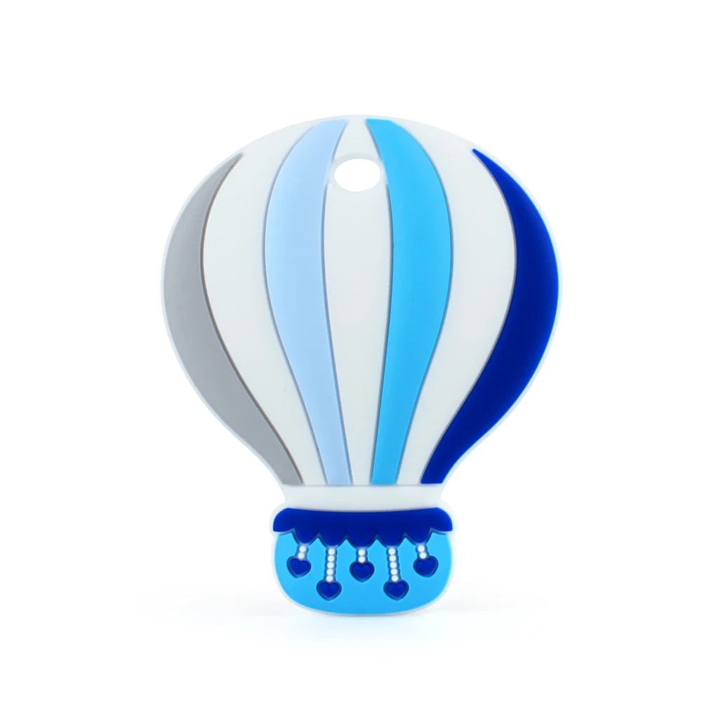 Colorful hot air balloon toy with vertical stripes in shades of blue, gray, and white. The balloon's bottom features dangling blue hearts and a scalloped blue design.