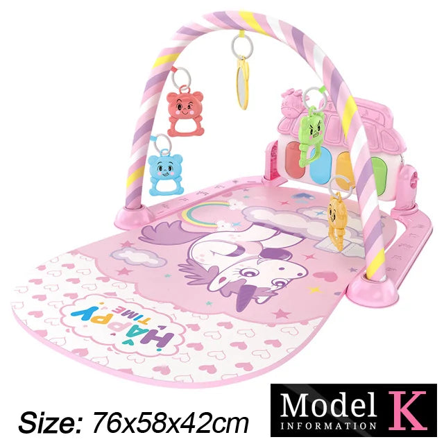 Baby play mat with a unicorn design, featuring a pastel arch with hanging toys. The mat reads "Happy Time" and measures 76x58x42cm. Model K information is shown.
