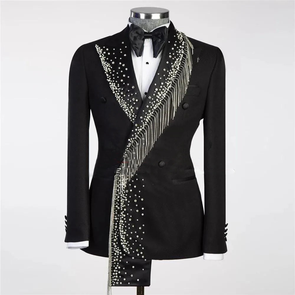 Elegant black tuxedo with a double-breasted design, adorned with sparkling rhinestones and fringe detailing. Features a black bow tie and white shirt underneath.