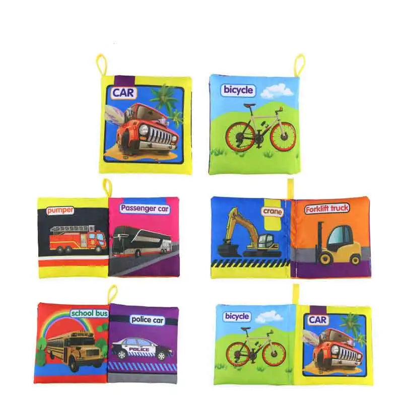 Colorful cloth books for children featuring illustrations and labels of vehicles like a car, bicycle, fire truck, passenger car, crane, forklift, school bus, and police car.