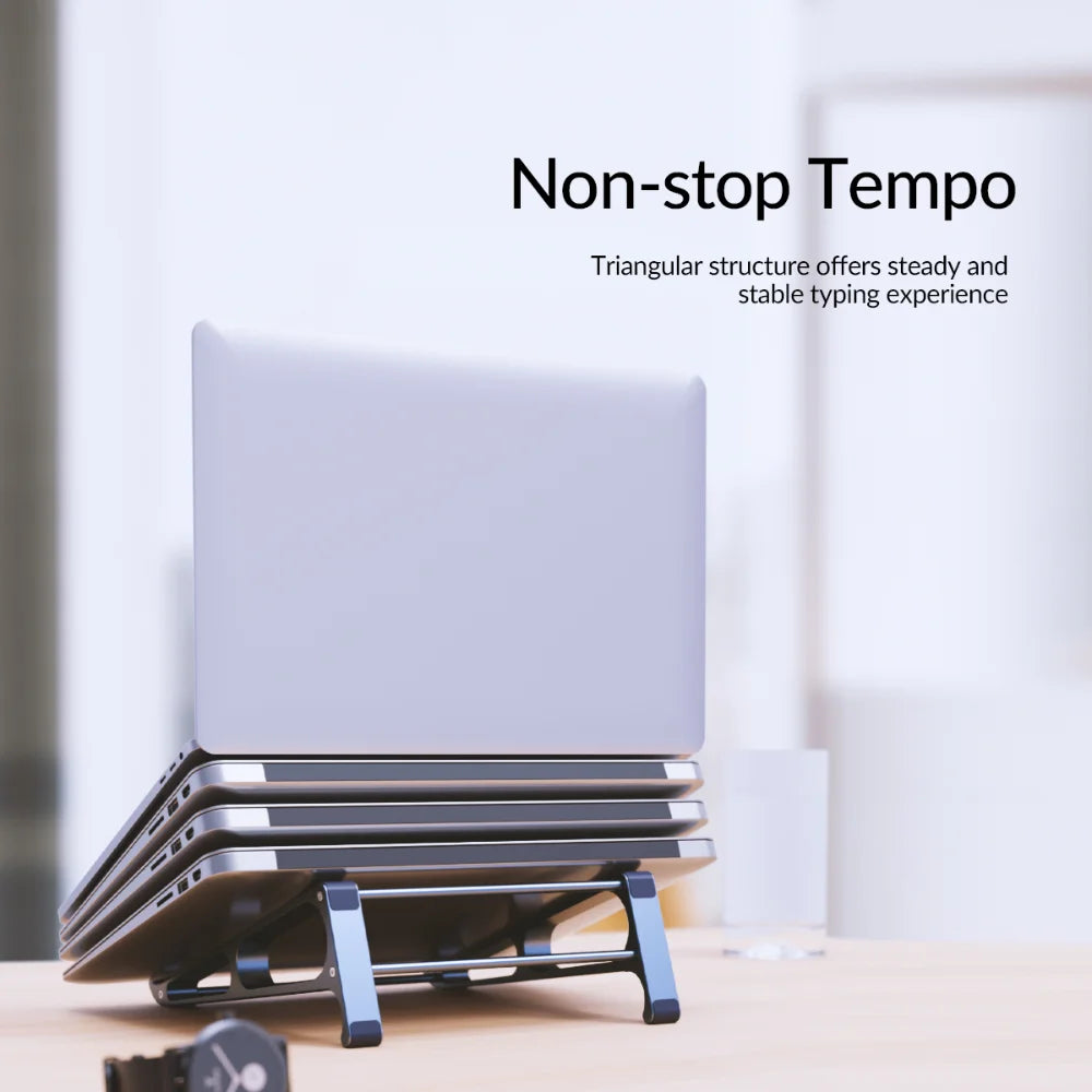 Laptop stacked on a triangular stand with the text "Non-stop Tempo." The stand is designed to provide a stable typing experience. A blurred watch is in the foreground.