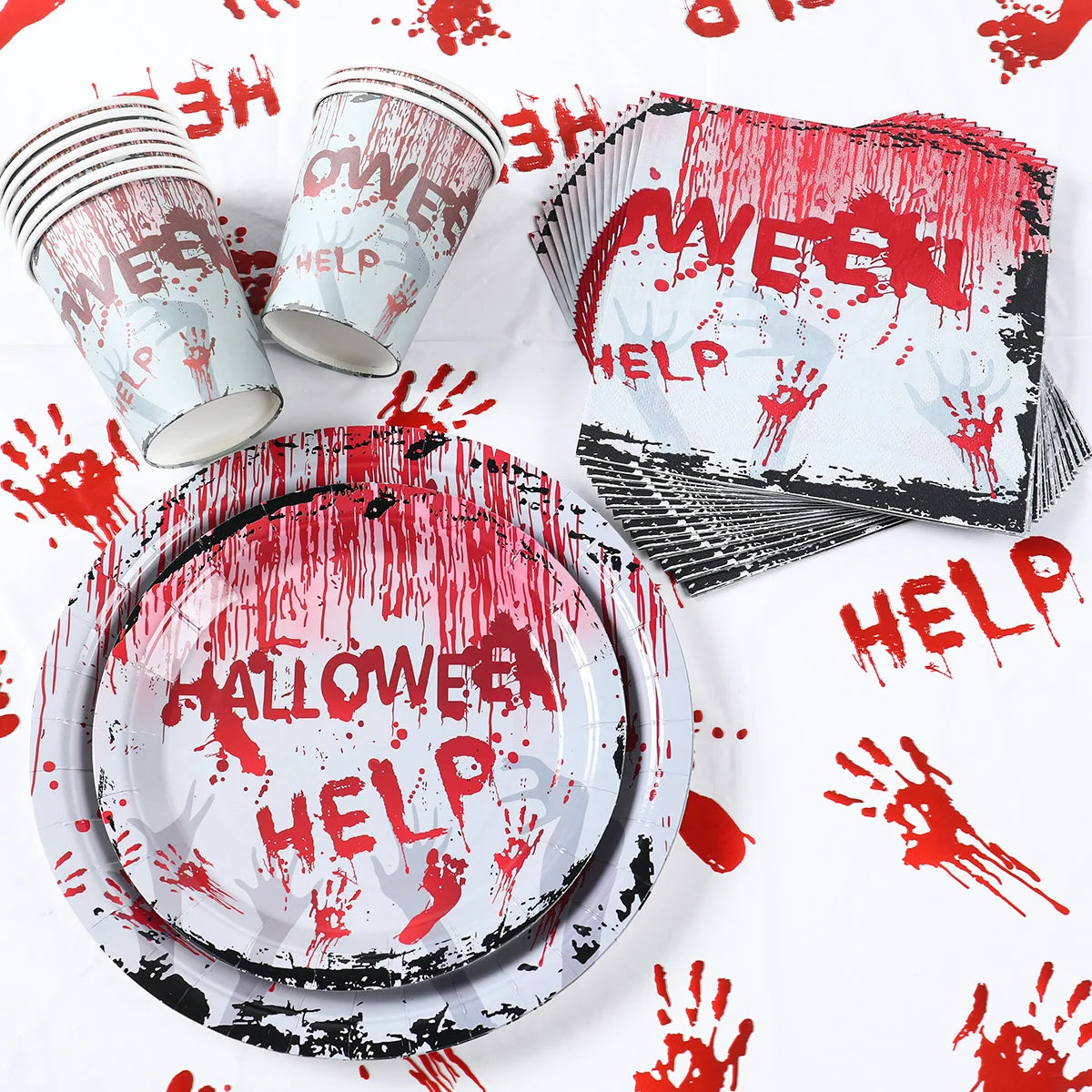 Halloween-themed party supplies feature “HELP” and "HALLOWEEN" in blood-red with bloody handprints on cups, plates, napkins, and a tablecloth.