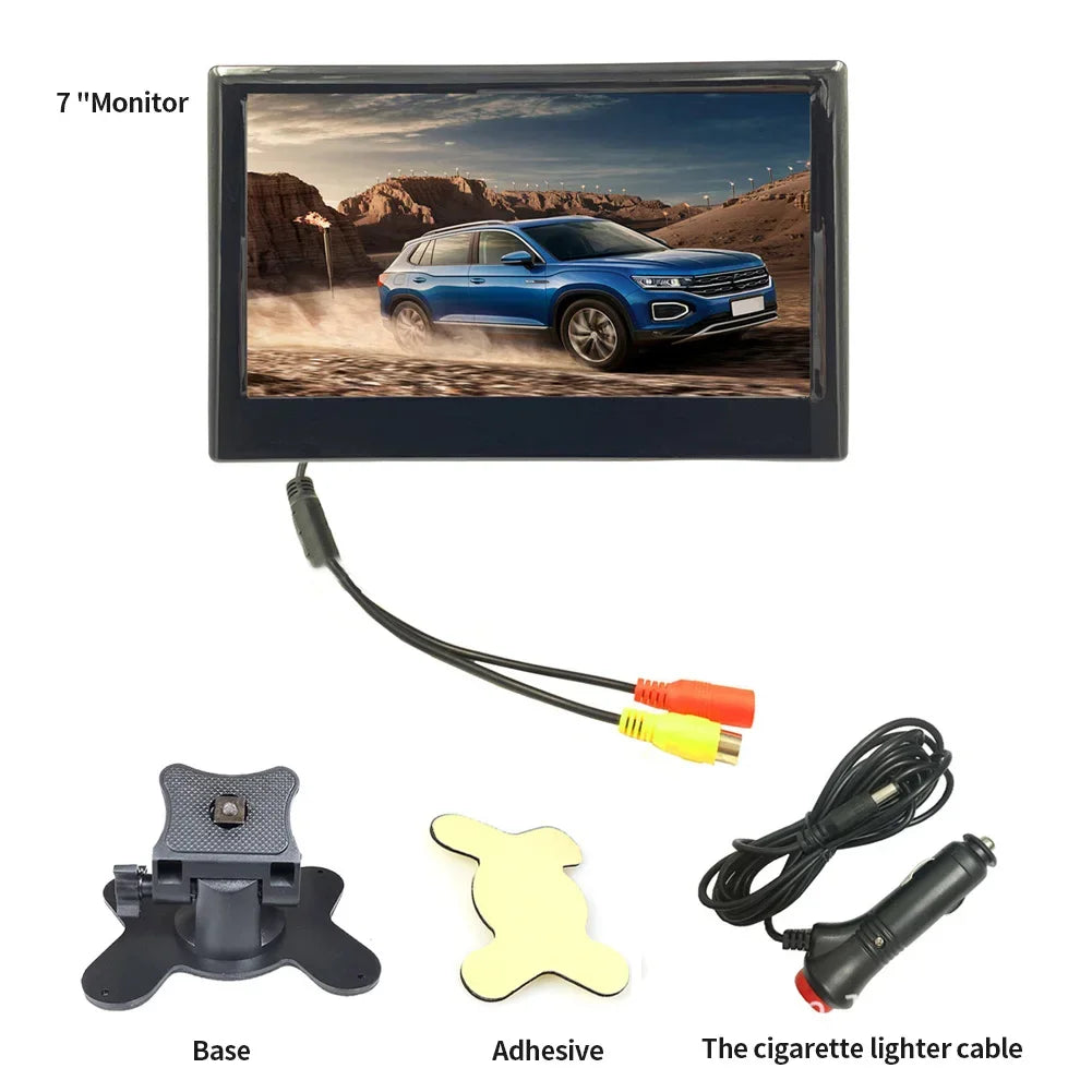 A 7-inch monitor displaying a blue SUV in a desert. Includes a base, adhesive, and a cigarette lighter cable for setup, with yellow and red connectors attached to the monitor.