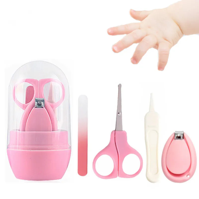 Pink baby grooming kit with scissors, nail clippers, file, and tweezers in a transparent case. A baby's hand reaching in from the right side of the image.