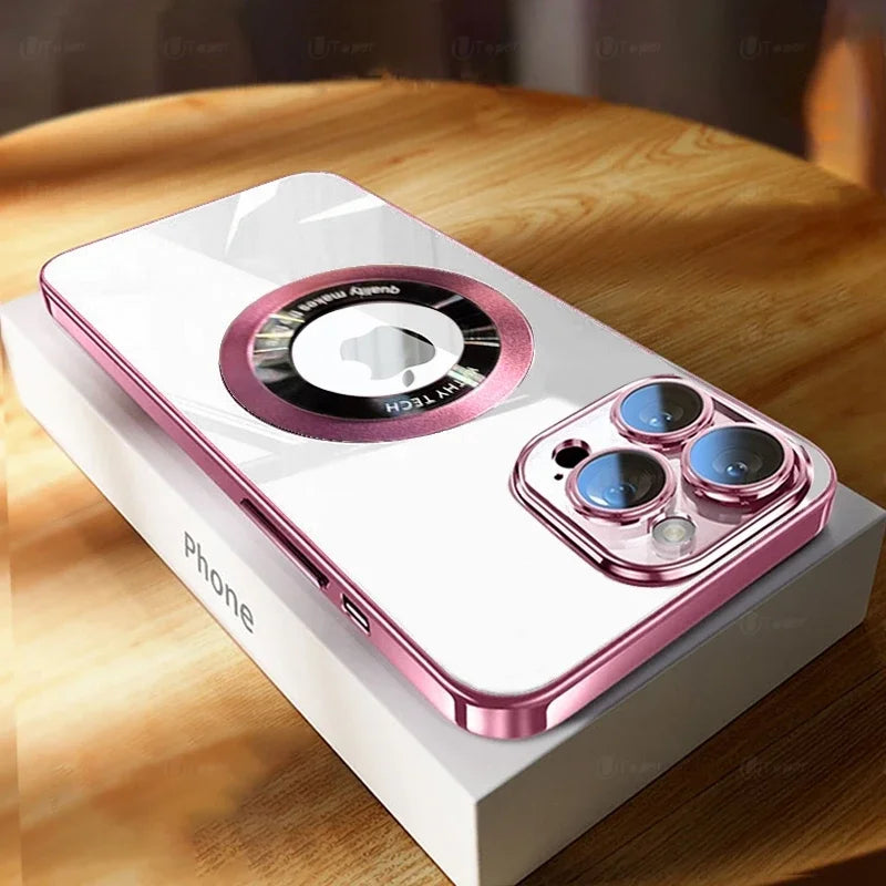 A smartphone with a reflective pink metal frame and triple-lens camera rests on a box labeled "Phone" on a wooden surface. A circular detail is visible on the back.
