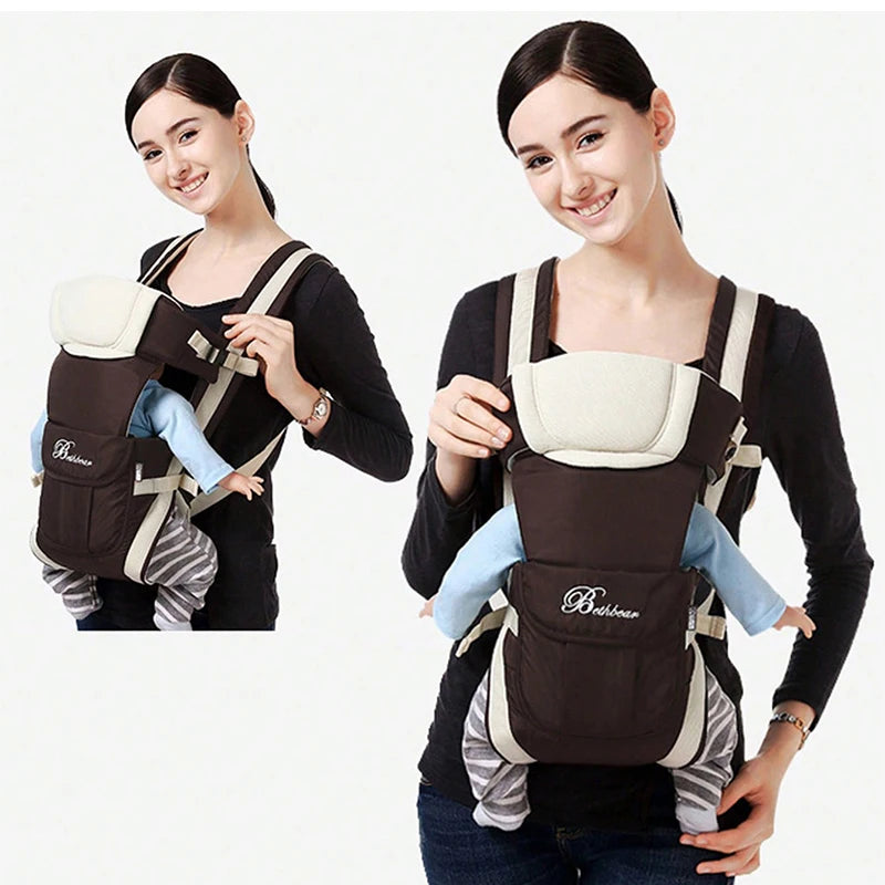 Smiling person wearing a black and white baby carrier with a baby doll dressed in blue and gray stripes inside. The carrier has a "Bebehome" logo on the front pocket.