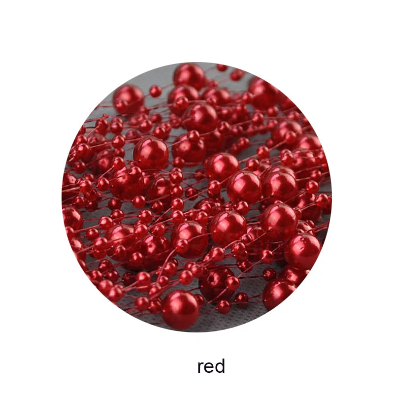 Clusters of small, shiny red beads arranged intricately on thin wires, creating a vibrant, decorative pattern.