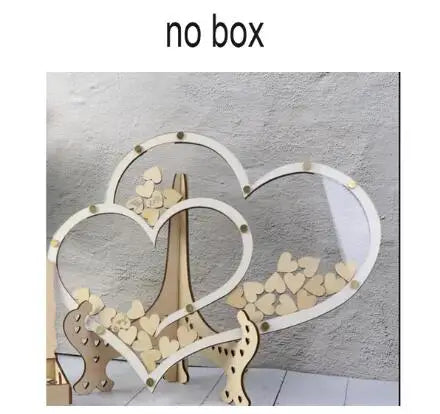 Heart-shaped wood and clear acrylic decorations filled with small wooden hearts, standing on a table against a textured gray wall. Text above reads "no box".