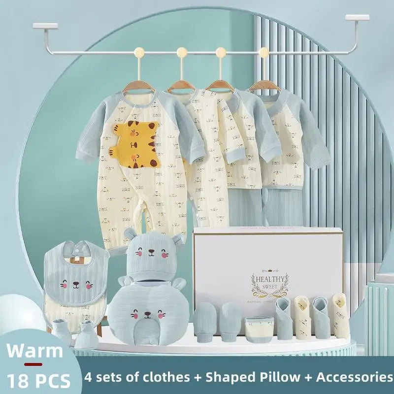 Baby clothing set featuring four outfits with animal designs, a bib, mittens, socks, and an animal-shaped pillow, all displayed on a pastel background.