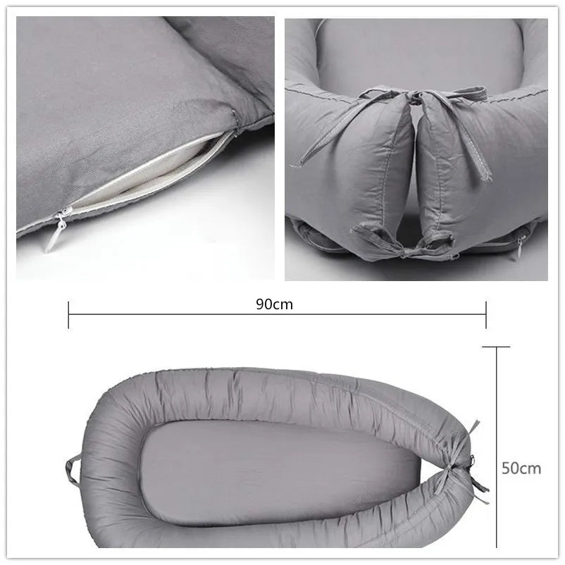 Gray baby nest with soft padded edges, shown in detail with zippers and tied ends. Dimensions are 90cm by 50cm. Designed for comfort and portability.