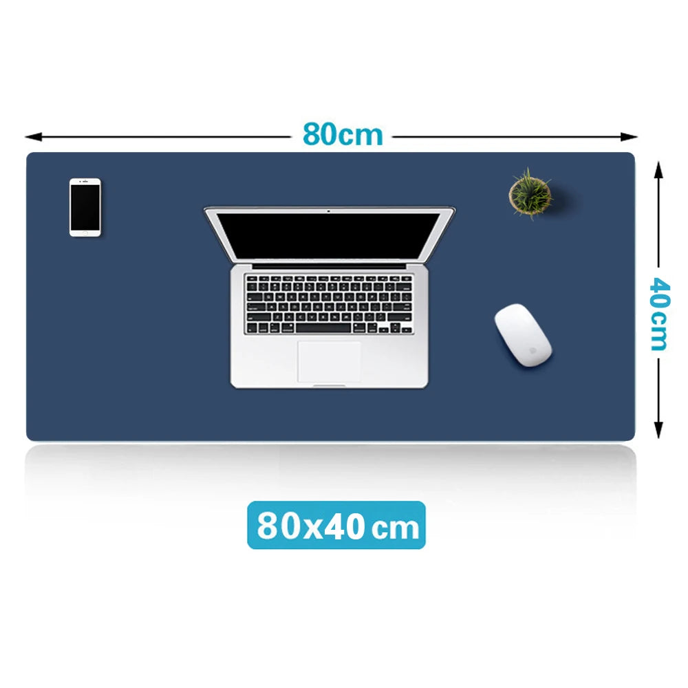Navy blue desk pad with dimensions 80x40cm featuring a laptop, mouse, mobile phone, and small plant, illustrating an organized workspace setup.