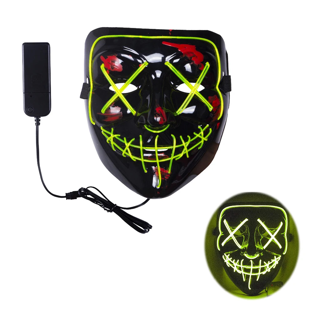 A black LED mask with green and red accents features glowing X eyes and a sharp smile. It includes a remote control for lighting effects, shown lit up in a circular inset.