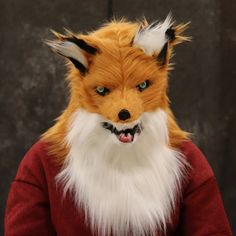 Person in a detailed fox costume with a red sweater. The costume features realistic orange fur, white beard, and pointed ears against a dark background.