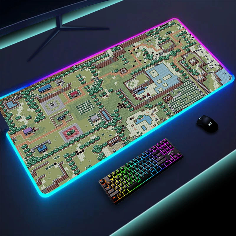 A glowing RGB gaming desk mat featuring a pixel art map design, paired with a colorful backlit keyboard and a mouse on a dark surface.