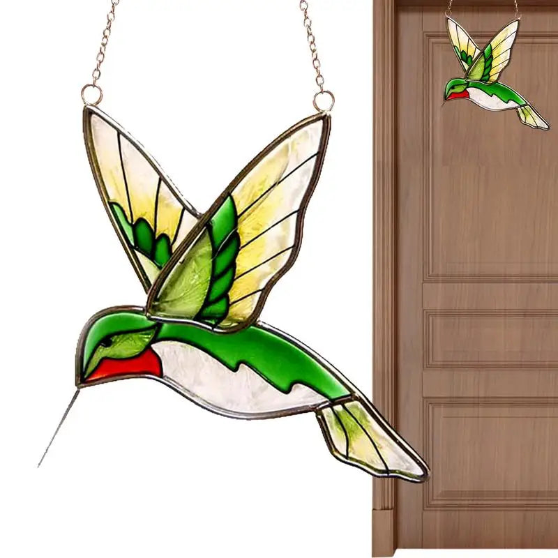 Stained glass hummingbird with vibrant green, yellow, and red hues, suspended by a chain. Close-up on the left, with a view of it hanging on a wooden door on the right.