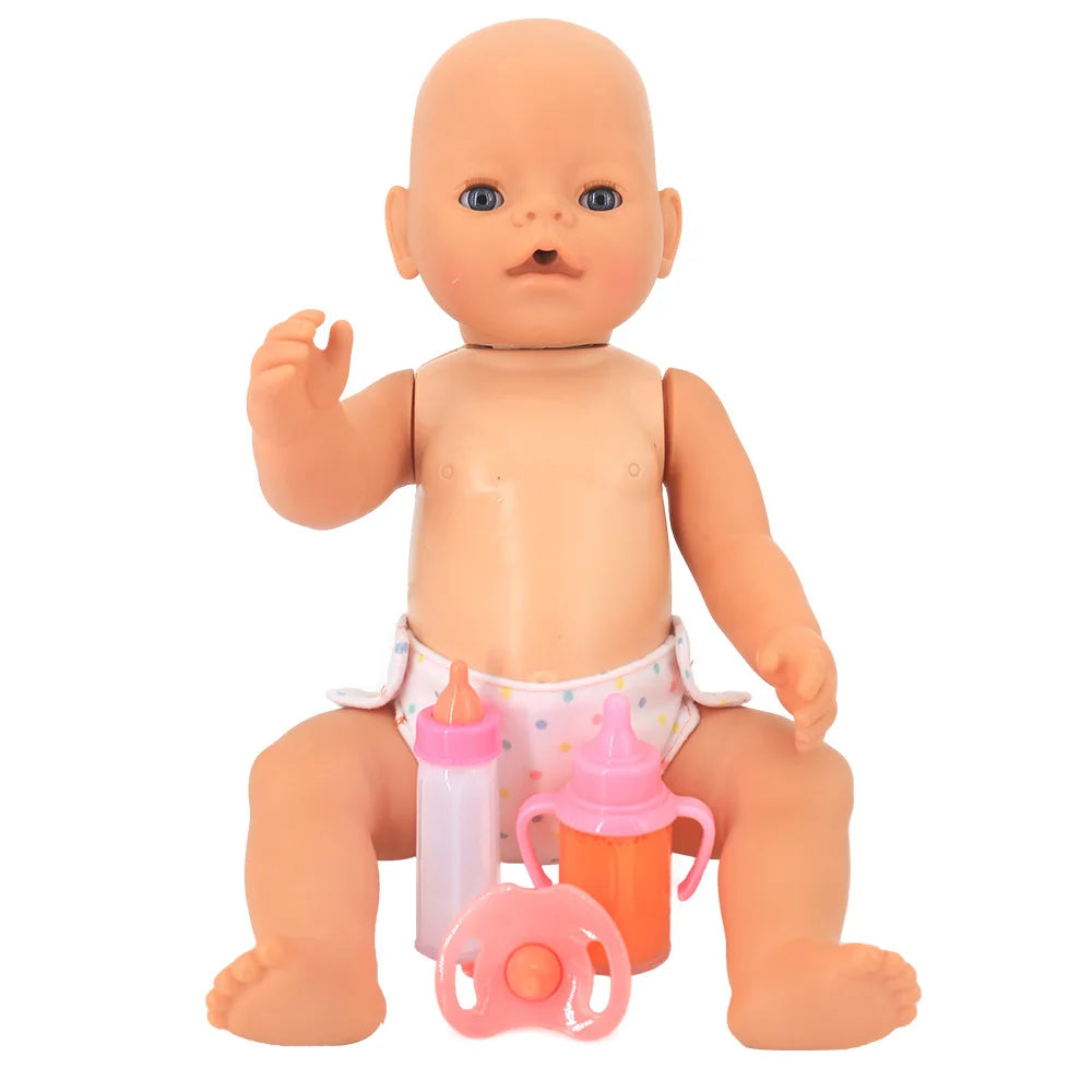 A bald baby doll in a polka dot diaper sits upright, surrounded by a pacifier and two toy bottles, one pink and one orange, against a white background.
