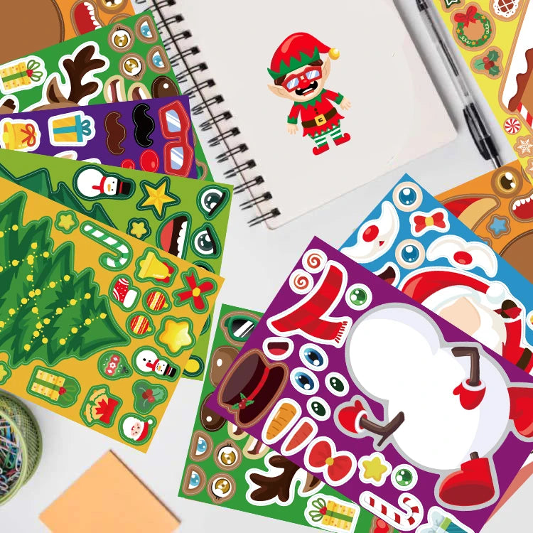 Festive sticker sheets with elf, snowman, tree, and reindeer designs surround an open notebook with an elf drawing. Pens and paper clips are nearby on a white surface.