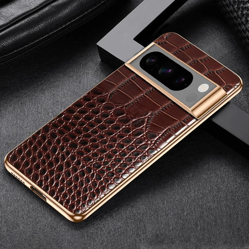Luxurious smartphone case with crocodile leather texture and gold accents, featuring a camera cutout with three lenses on a dark, textured background.