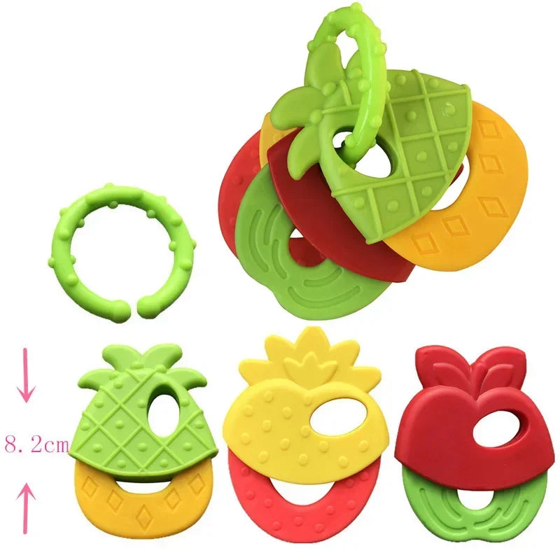 Colorful fruit-themed baby teether set with textured silicone shapes, including pineapple and strawberry designs, connected by a green ring. Length is noted as 8.2 cm.