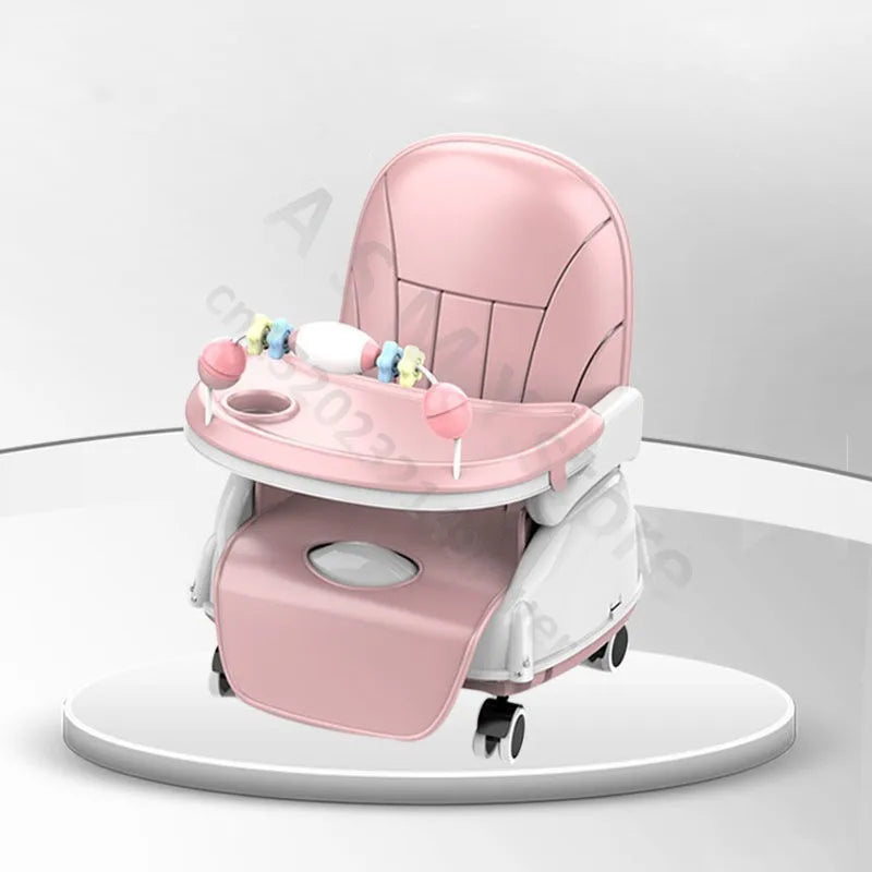 Pink baby high chair on a round platform, featuring a tray with toy attachments and a cup holder, white base, and small wheels for mobility, set against a neutral background.