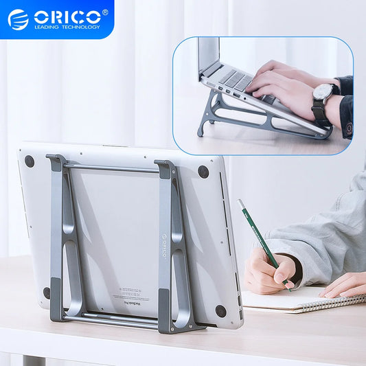 A person writes in a notebook beside a laptop elevated on an Orico stand, providing an ergonomic angle for typing. The inset shows hands typing on the laptop using the stand.