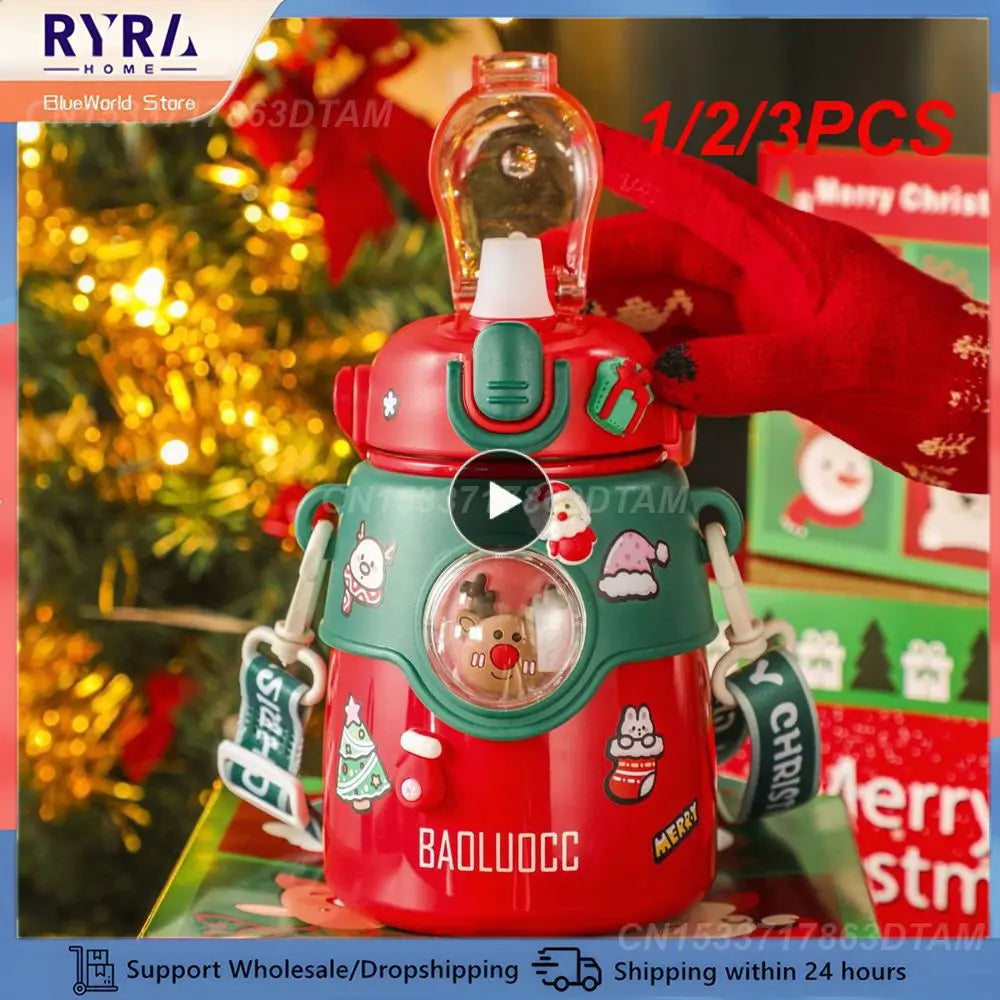 Red and green festive-themed water bottle decorated with Christmas stickers and a strap, near a Christmas tree and presents. Text: "BAOLUOCC", with delivery icons below.