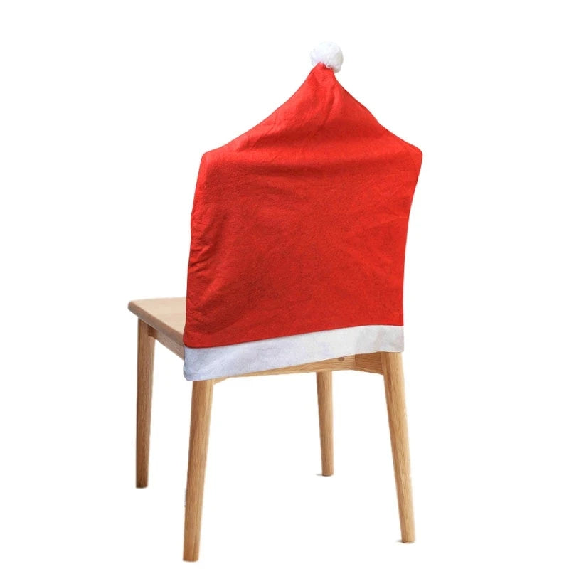 A wooden chair with a red Santa hat chair cover, featuring a white trim and pom-pom, creating a festive holiday-themed decoration.