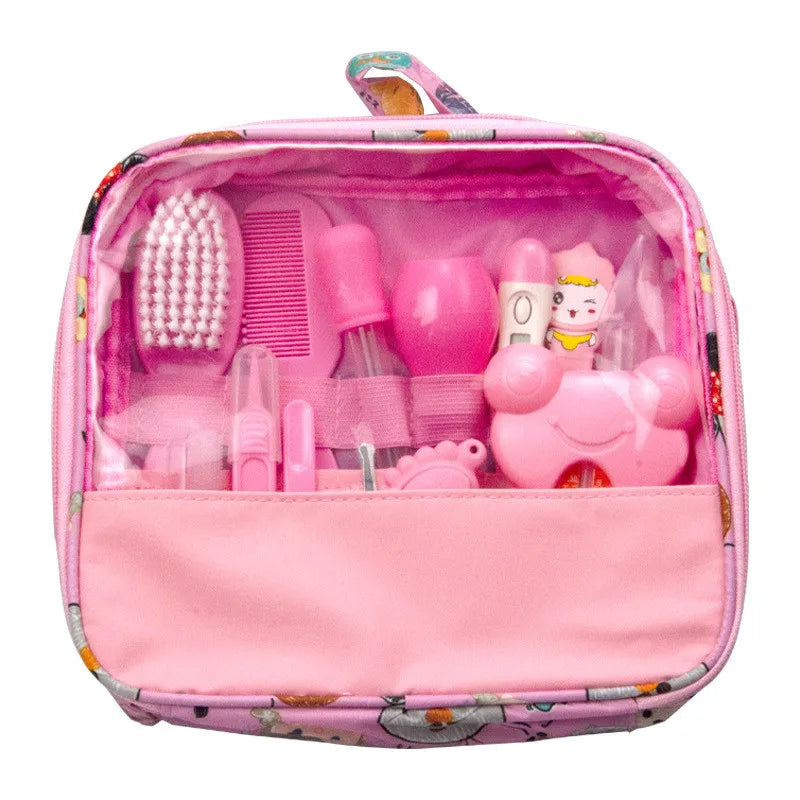 Pink play medical set in an open pink zippered case, containing a toy brush, comb, syringe, and other medical tools, all arranged neatly inside clear compartments.