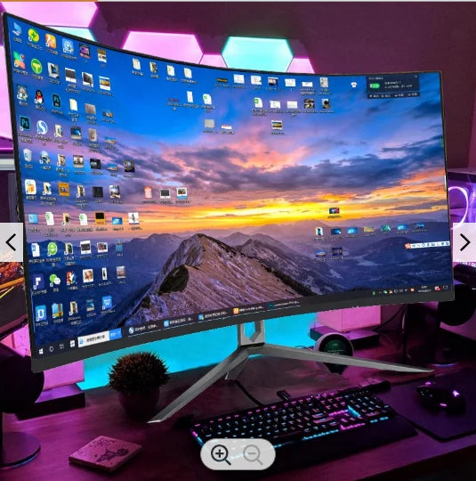 A large curved monitor displays a scenic mountain sunset, surrounded by colorful LED lights and a keyboard. Desktop icons are spread across the screen.