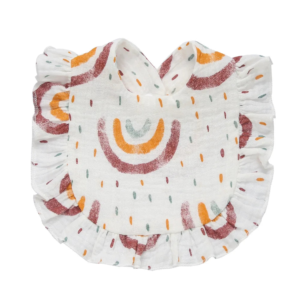 White baby bib with ruffled edges, featuring a colorful rainbow and dot pattern in orange, green, and burgundy hues.