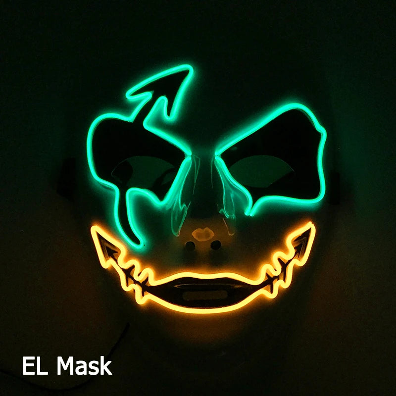 Glowing mask with green eye outlines and jagged orange mouth resembling a sinister face. The black background enhances the neon effect, creating a spooky atmosphere. Text reads "EL Mask."